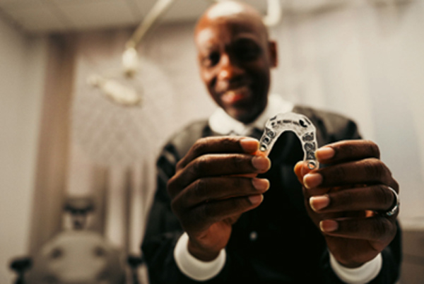 Doctor Holding Dental Surgical Guide